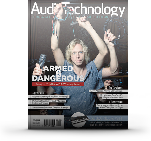 Adrian Breakspear on the cover of Audio Technology magazine holding studio microphones and cables during a music production feature shoot